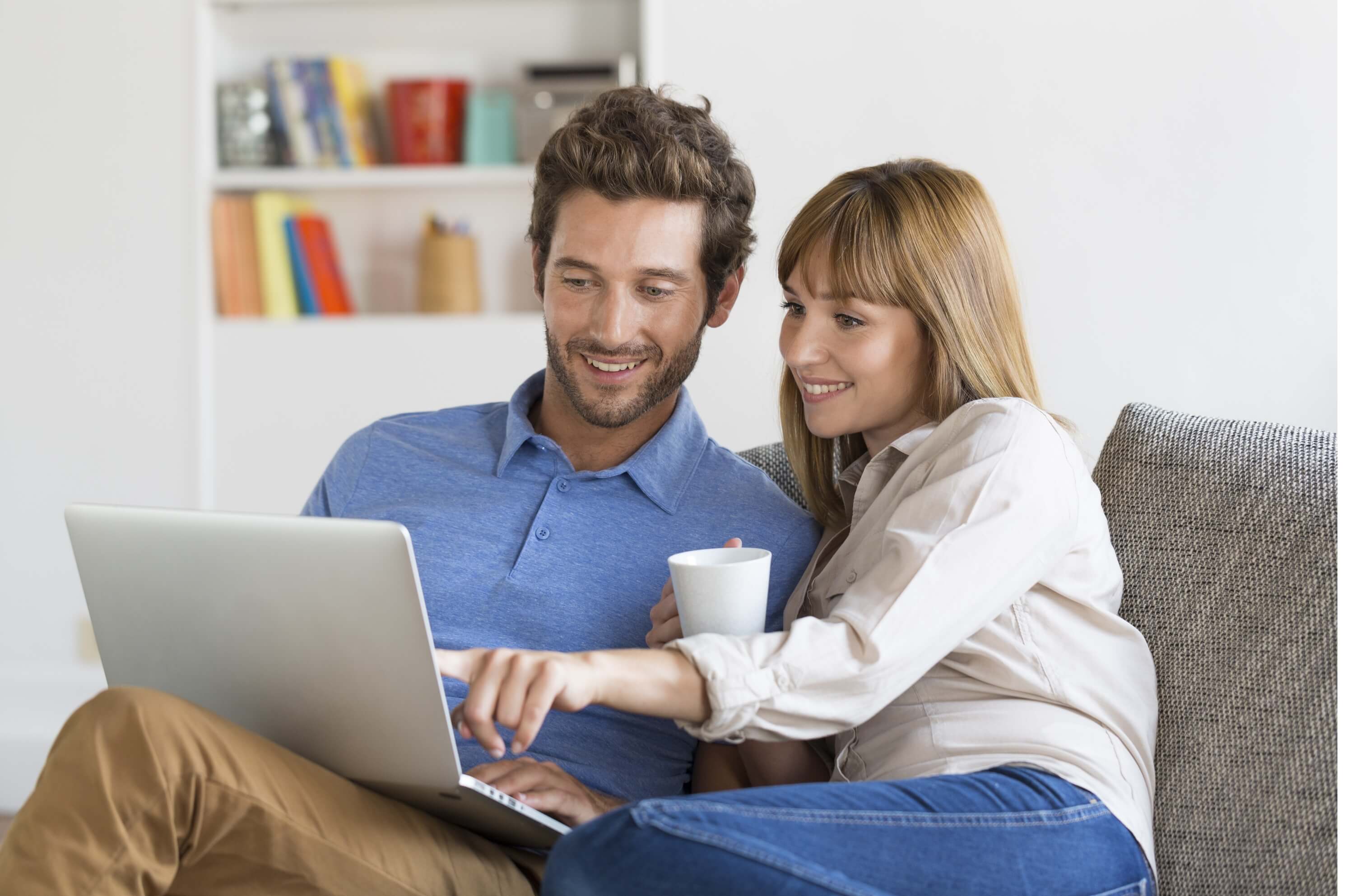 Man and woman sat looking at laptop